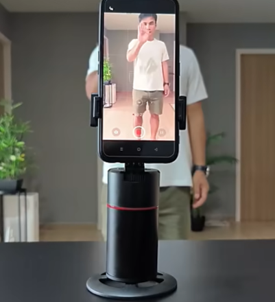 AI-Track Pro P02 smart face tracking gimbal on a tripod follows a creator using hand gestures to control the smartphone camera