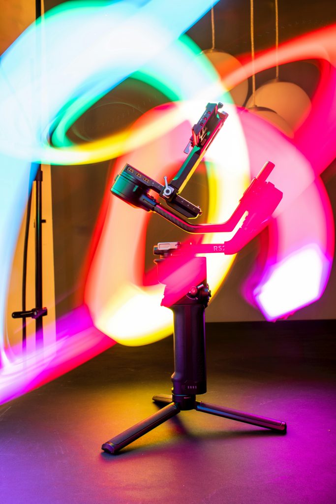 Professional camera gimbal with vibrant RGB light trails for 2026 content creation - YourStation.shop